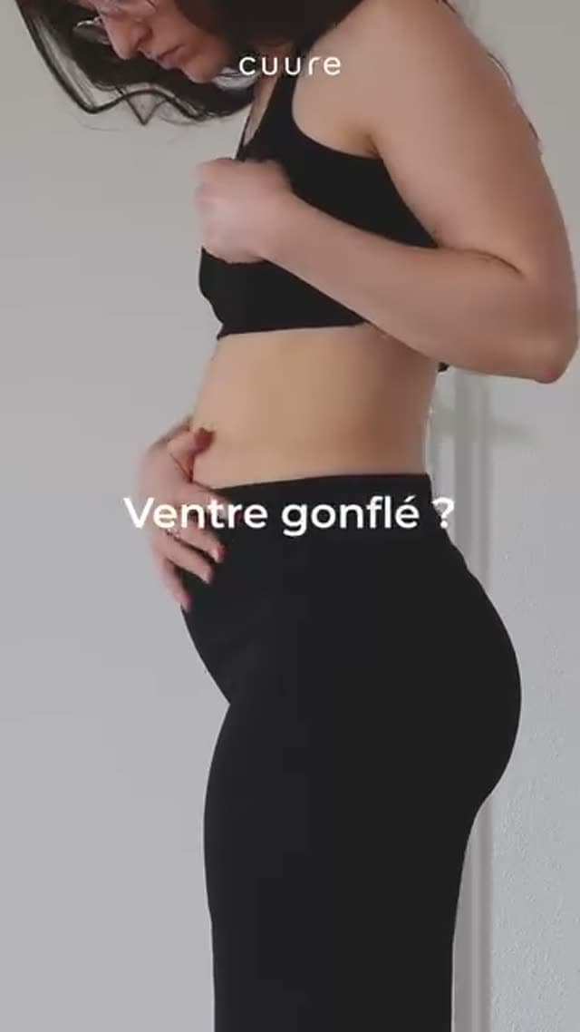 Health and wellness ad example: Cuure supplements video Meta ad, ugc selfie format. French-language handheld video: a woman in black activewear touches her stomach under the caption ventre gonflé, a bloated stomach.